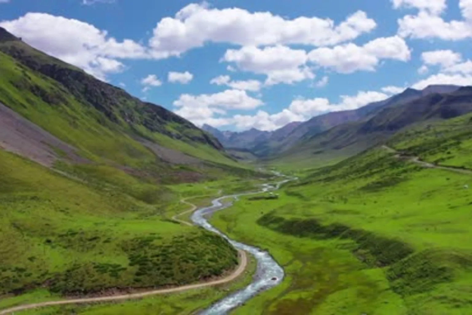 Mountain road through green Ili valleys